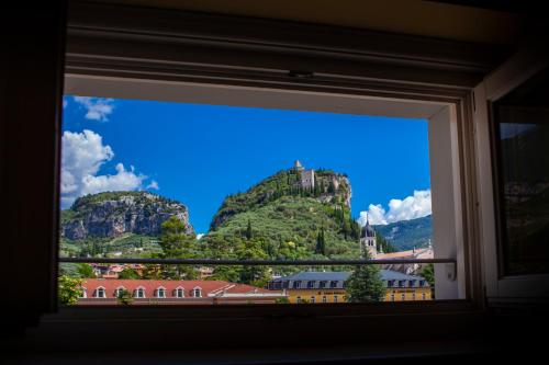 a view of a mountain from a window at Hotel Olivo in Arco
