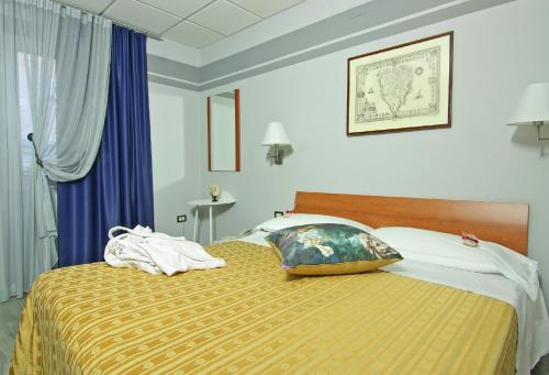 a hotel room with a bed and a window at Albergo Al Viale in Trieste