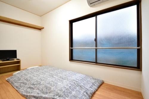 Tempat tidur dalam kamar di Senju Tamuraya