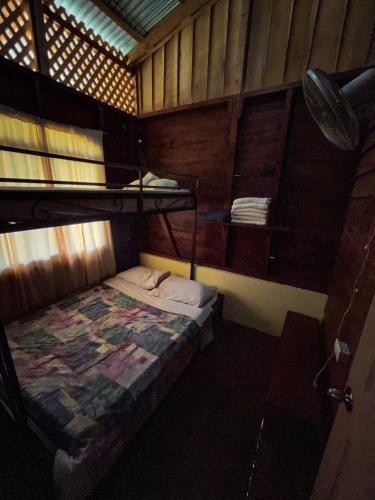 a small room with a bunk bed in a cabin at Princesa de la Luna Ecolodge in Fortuna