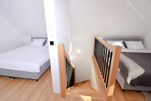 a small bedroom with a bed and a staircase at Gwiazda Kaszub in Chmielno