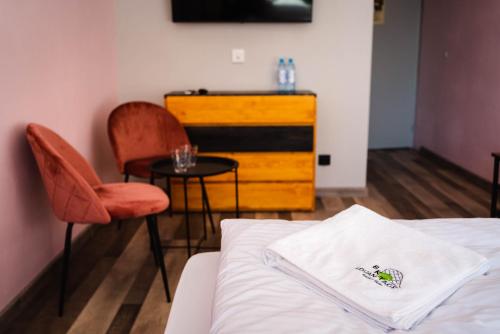 a bedroom with a bed and a table and chairs at Tenis Park Advantage in Bielsko-Biala
