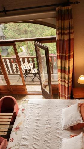 a bedroom with a bed and a view of a balcony at Mas D'en Roqueta in Aravell