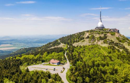 a church on top of a hill with a chapel at Horská Chata Ještědka in Světlá pod Ještědem