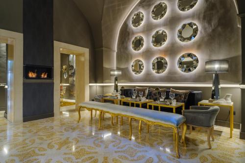 a lobby with a table and chairs and a fireplace at Maison Boutique At Daniela in San Pietro in Lama