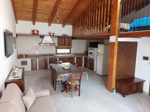 a kitchen with a table and a couch in a room at La Casa Sull'aia,AV in Santo Stefano del Sole