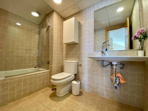 a bathroom with a toilet and a sink at Exclusive Beachfront Penthouse in Almayate Alto