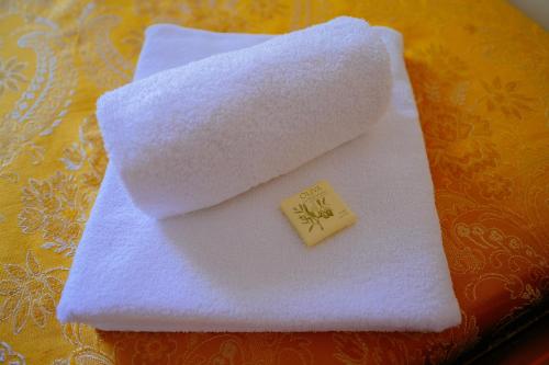 a white towel with a small cube on top of it at Casa per Ferie JPII Dom Polski in Rome