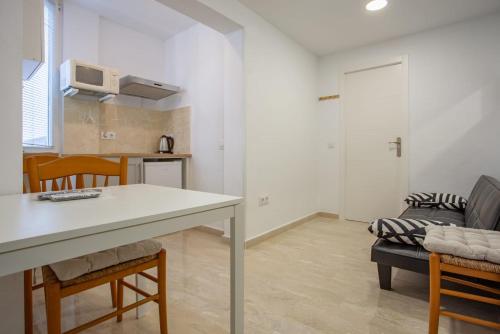 a kitchen and living room with a table and chairs at altea home centre one badroom in Altea