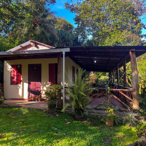 a small white house with a porch at Princesa de la Luna Ecolodge in Fortuna