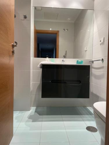 a bathroom with a sink and a mirror at El rincón de Poniente in Gijón