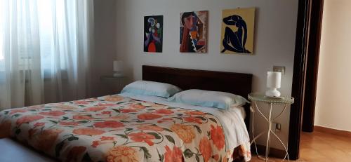 a bedroom with a bed with a floral comforter at Fabiola B & B in Marino