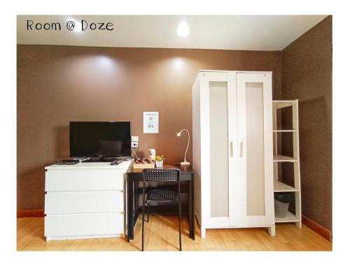 a room with a desk with a computer and a cabinet at Room@Doze in Nonthaburi