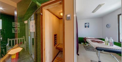a hallway with a room with a bed and a glass door at Grami Hotel in Bansko