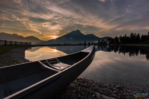 a boat sitting on the shore of a lake at Ferienhaus Antoinette in Biberwier