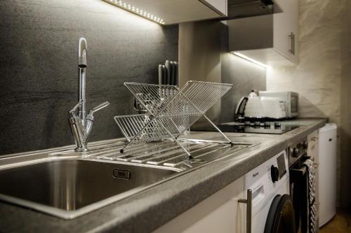 a kitchen sink with a dish drying rack on it at Crieff House in Crieff