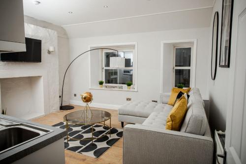 a living room with a couch and a table at Crieff House in Crieff
