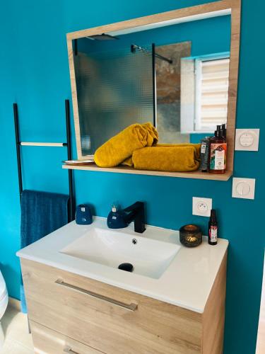 a bathroom with a sink and a mirror at Mb Room - Appartement jacuzzi 4 étoiles Merveille in Puget-sur Argens