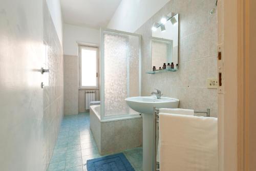 a bathroom with a sink and a mirror and a shower at Di fronte alla Basilica di San Paolo in Rome