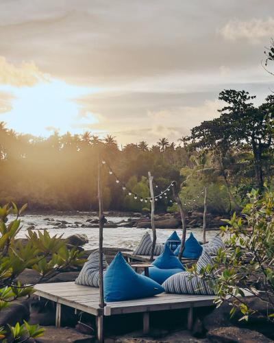 a group of blue pillows sitting on a table next to a river at Shantaa Resort, Kohkood in Ko Kood