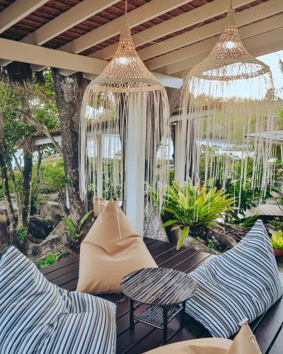 a patio with two chairs and chandeliers at Shantaa Resort, Kohkood in Ko Kood