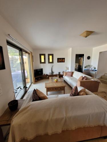 a bedroom with a large bed and a living room at Villa Azure Sea, Istron in Istron
