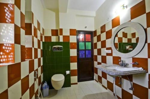 a bathroom with a sink and a mirror at Rani Mahal Hotel in Jaipur