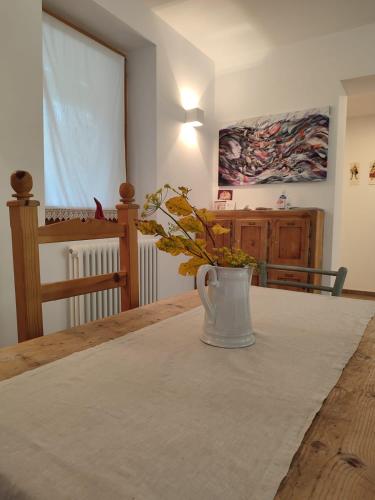 a vase of flowers sitting on a table in a room at Storie di bosco in Villa Lagarina