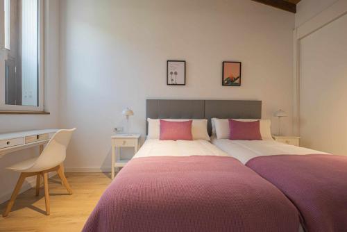 1 dormitorio con 1 cama grande con sábanas rosas y blancas en Los Adelantados El Aljibe Live Canarias en La Laguna