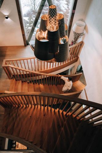 a room with wooden stairs with a table with vases at Naturresort PURADIES in Leogang