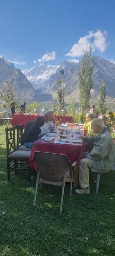 a group of people sitting at a table eating at Karakorum View Hotel Karimabad Hunza in Hunza