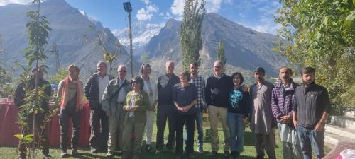 a group of people posing for a picture with mountains in the background at Karakorum View Hotel Karimabad Hunza in Hunza