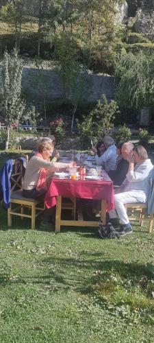 a group of people sitting at a picnic table at Karakorum View Hotel Karimabad Hunza in Hunza