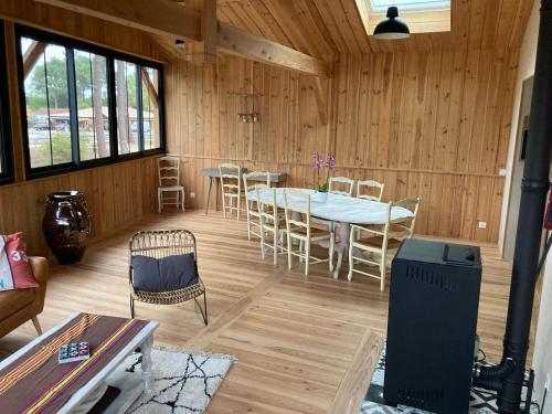 une salle à manger avec une table et des chaises dans une pièce dans l'établissement :Le tchanqué du bassin d'arcachon, à Lège-Cap-Ferret