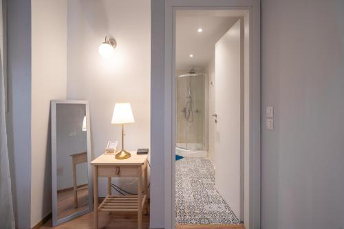 a room with a bed and a table and a mirror at Exclusive apartment in the heart of Athens in Athens