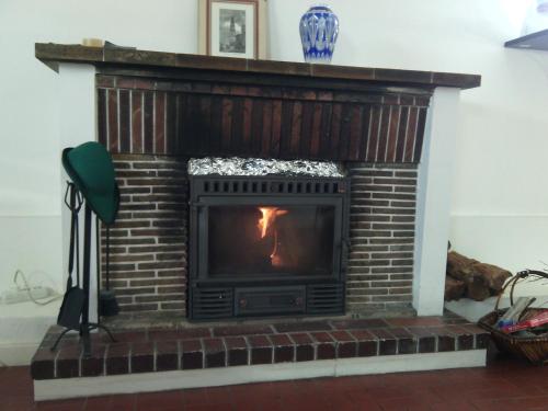 a fire place with a brick wall and a brick fireplace at AirPorto Hostel in Maia
