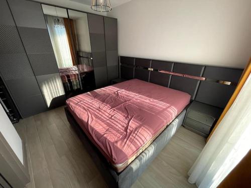 a bedroom with a bed with a pink blanket at Denize Sıfır, Havuz Manzaralı, Bodrum Merkezde 1+1 in Bodrum City