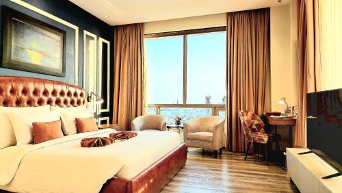 a hotel room with a bed and a large window at Best Western Premier Hotel Gulberg Lahore in Lahore