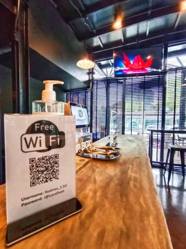 a bar with a free wifi sign on a table at Room@Doze in Nonthaburi