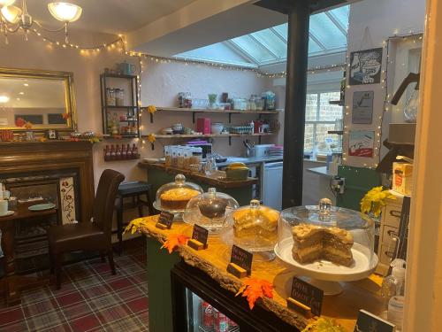 a restaurant with a counter with some food on it at Talbot House Bed & Breakfast and Tearoom in Pateley Bridge