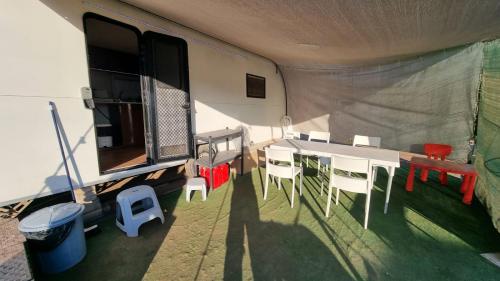 a dining room with a table and chairs in a tent at קרוון in Eilat