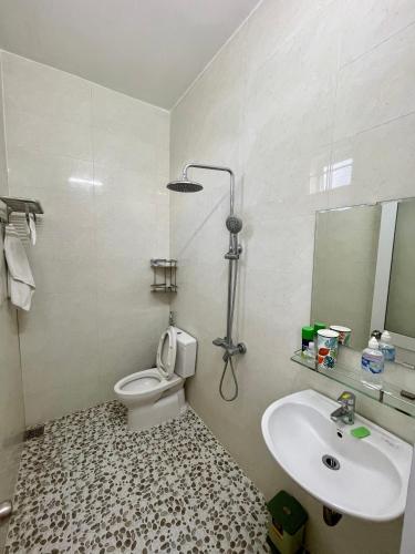 a bathroom with a toilet and a sink at Garden House Nha Trang in Nha Trang