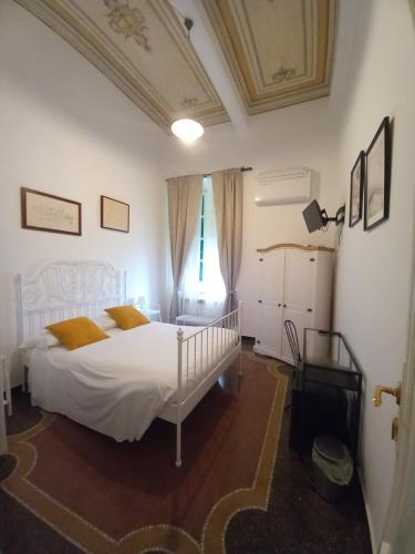 a bedroom with a white bed and a window at AFFITTACAMERE SAN BIAGIO in Genoa