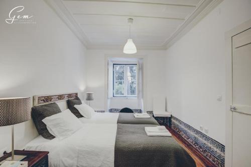Un pat sau paturi într-o cameră la Casa Dos Azulejos - Lapa