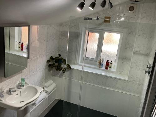 a white bathroom with a sink and a shower at Park View in Chester