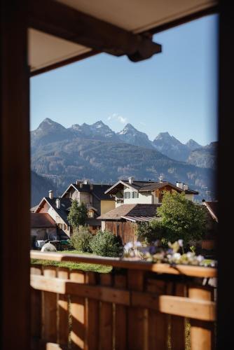 a view of a town with mountains in the background at Hotel La Montanara Predazzo in Predazzo