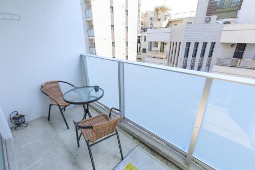 a balcony with two chairs and a table on it at Japan Hinata Hotel 池下駅 1番出口 徒歩2分 1LDK 50平米 8名 in Nagoya