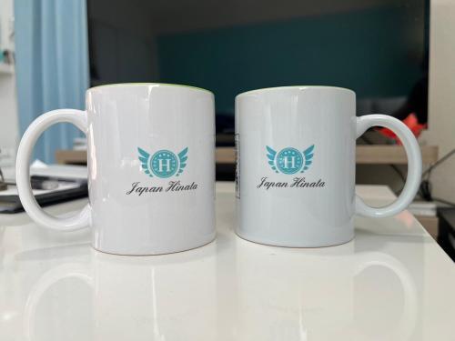 two coffee mugs sitting on top of a table at Japan Hinata Hotel 池下駅 1番出口 徒歩2分 1LDK 50平米 8名 in Nagoya