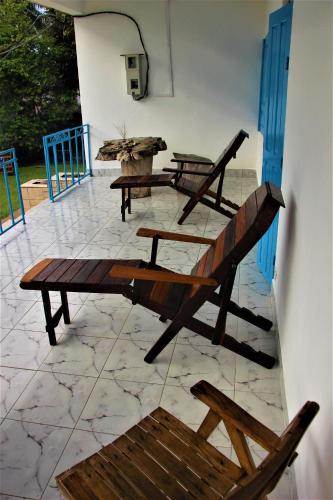 a wooden bench sitting on top of a patio at OCEAN-SI Mansion in Kribi
