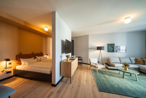 ein Schlafzimmer mit einem Bett und ein Wohnzimmer in der Unterkunft Black F Tower - Serviced Apartments in Freiburg im Breisgau